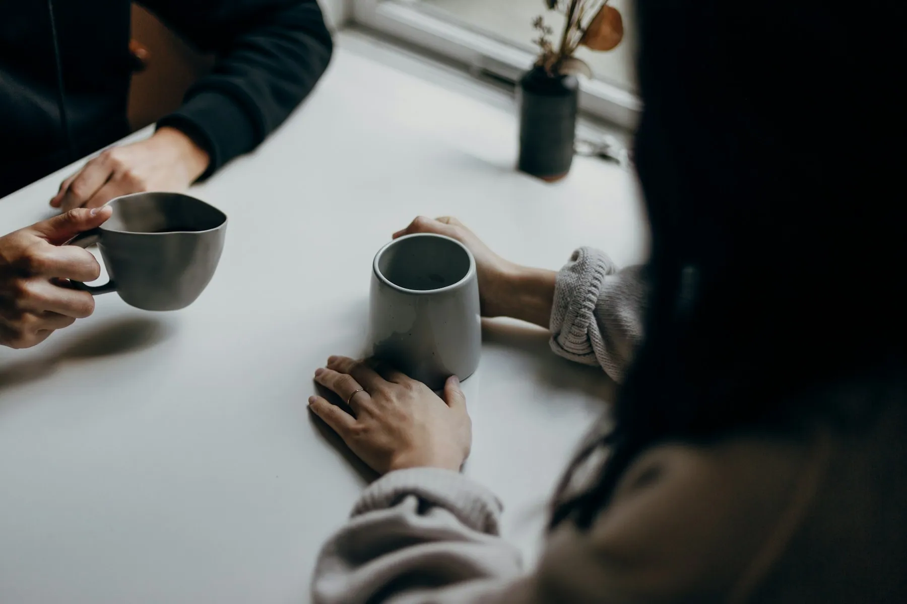 People collaborating around a table with coffee