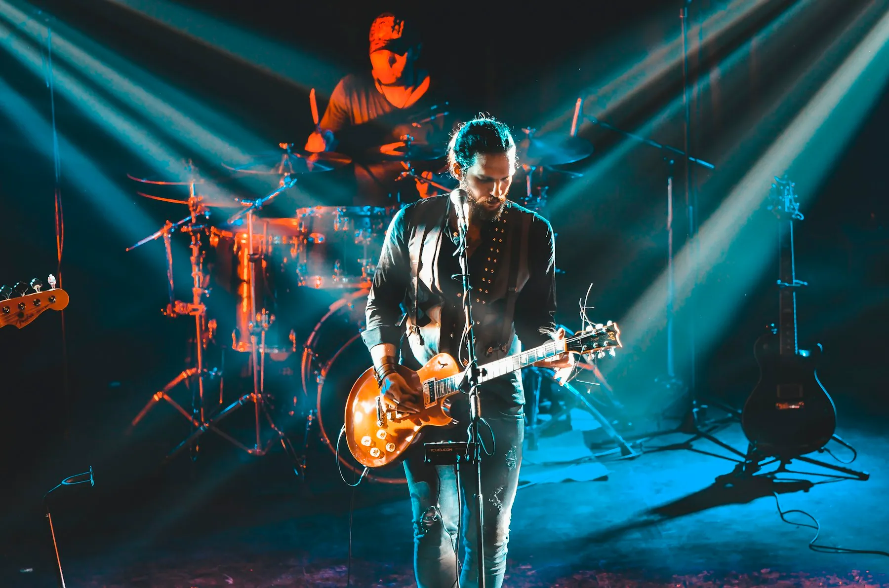 A live band performing under dramatic stage lights