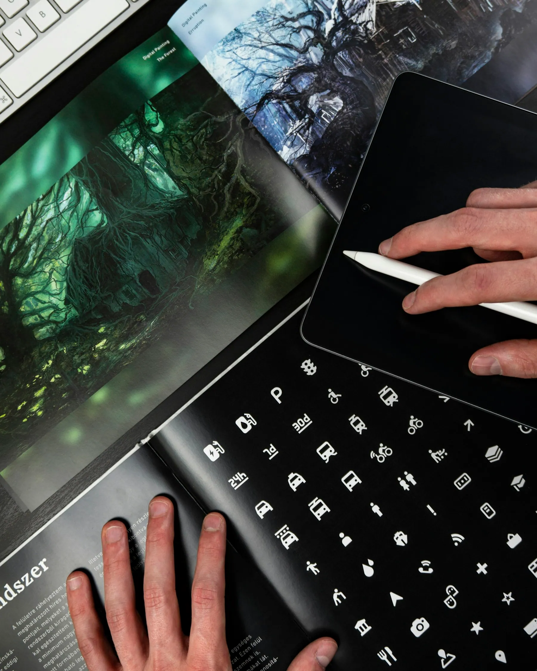 Hands working on a laptop in moody light