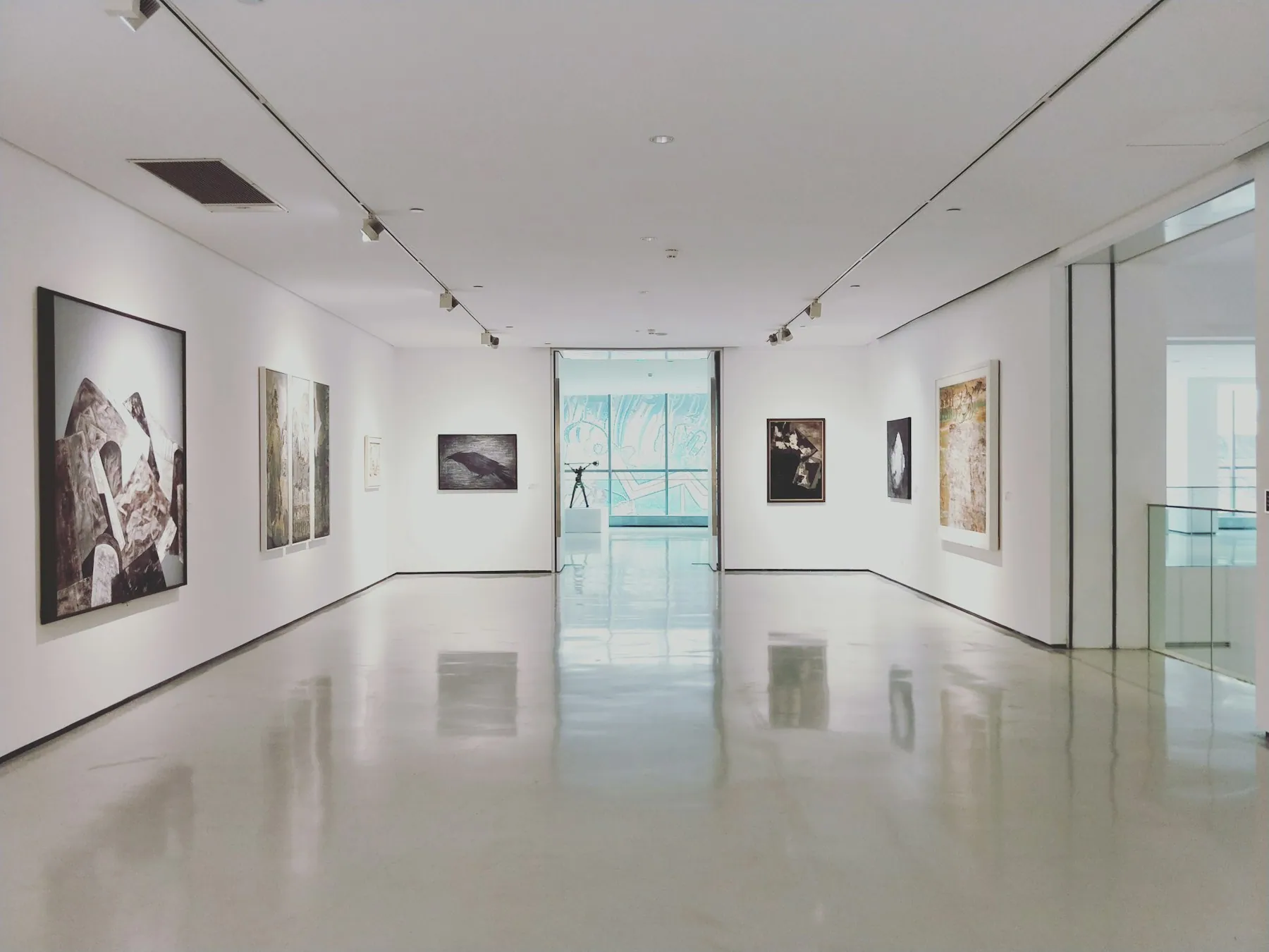 A bright gallery interior with framed works