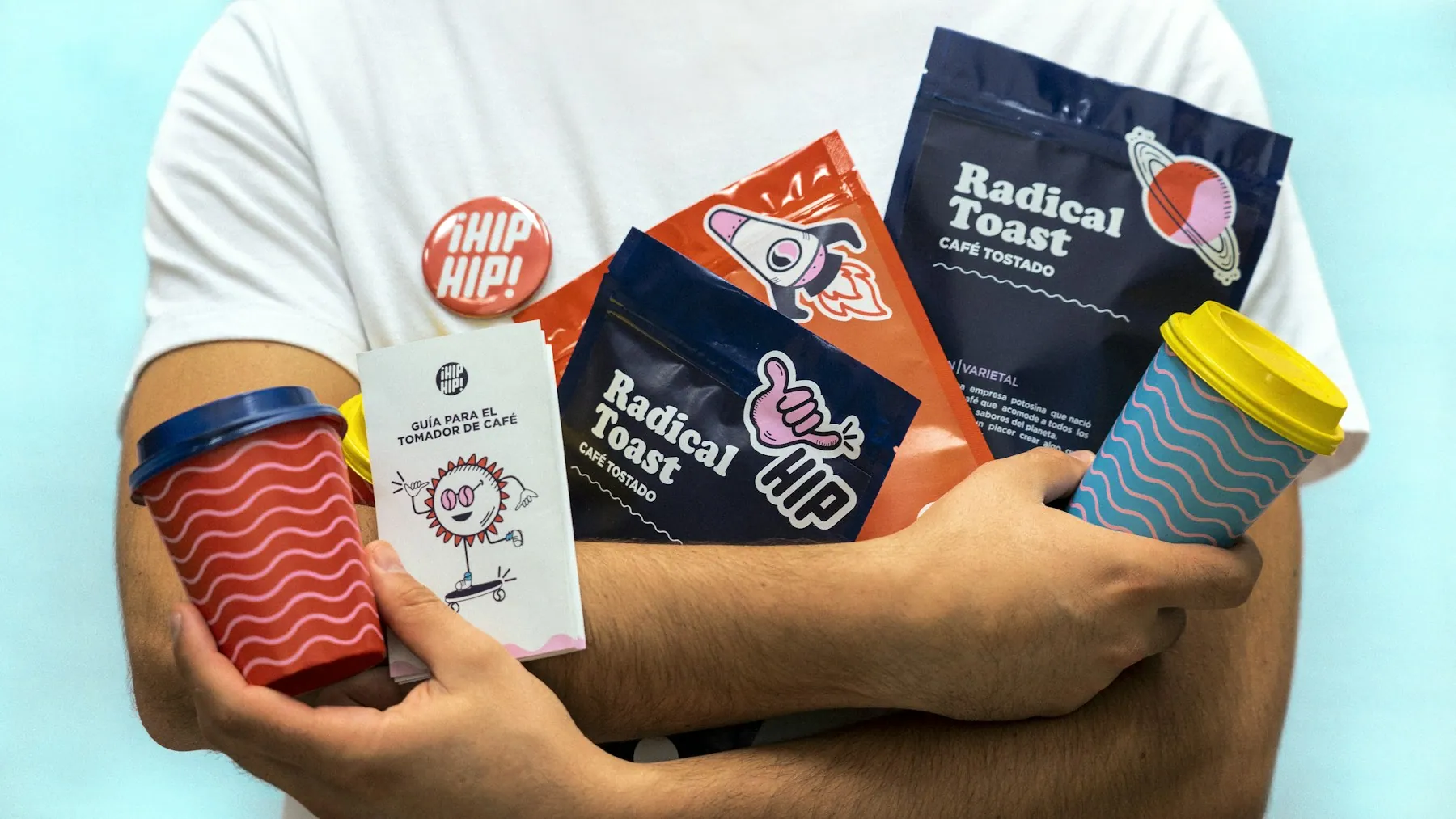 Branded packaging and coffee cups held in hand