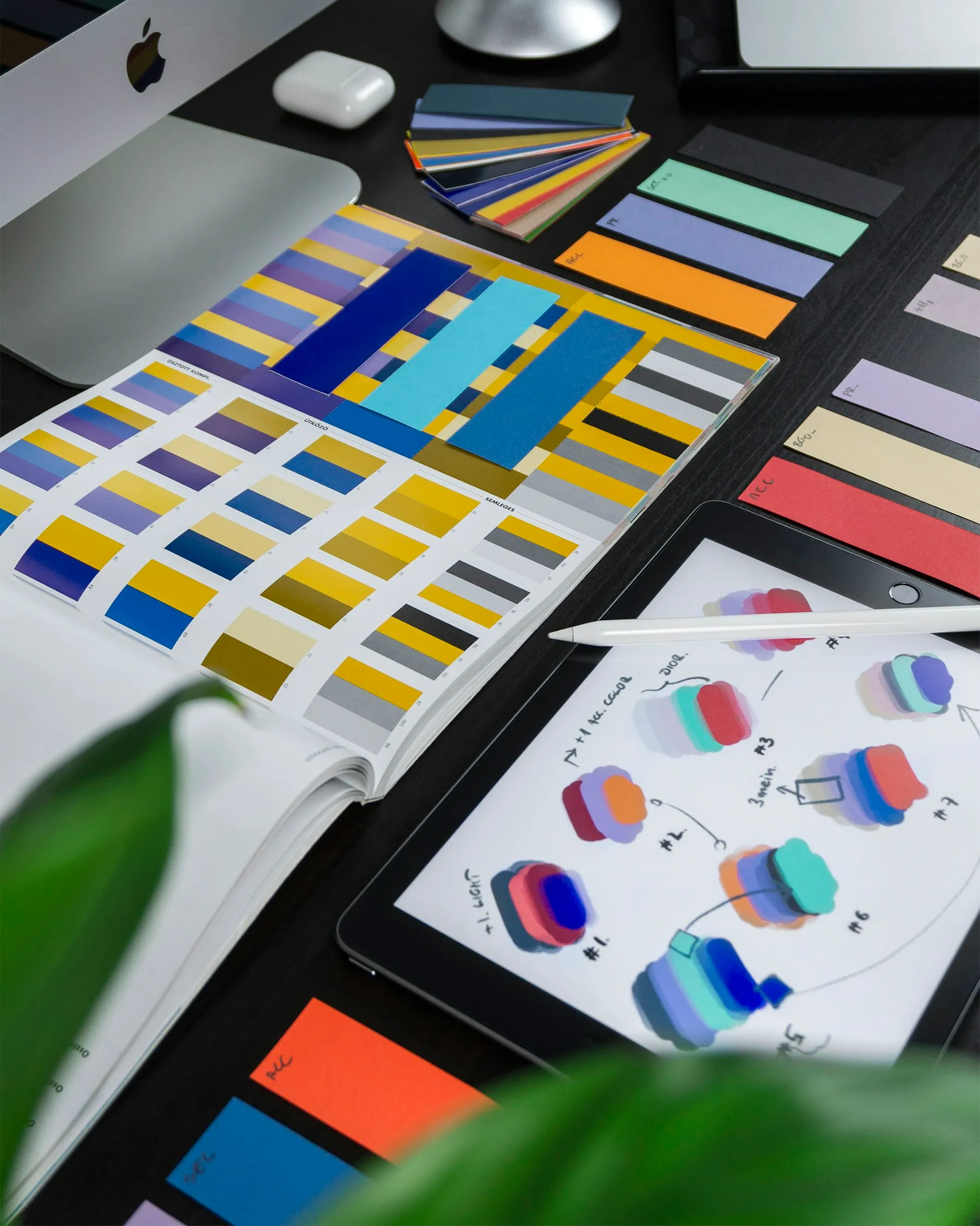 Colorful printed design swatches laid out on a desk